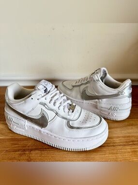 Nike White Sneakers with Metallic Silver Swoosh